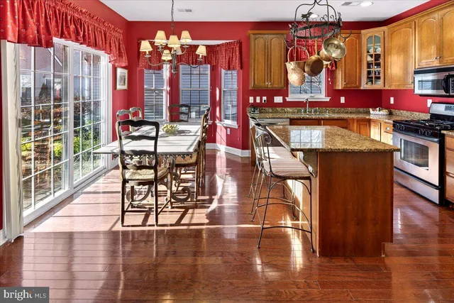 a room with lots of wooden furniture and a large window