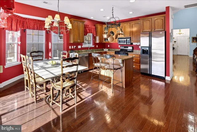 a view of a dining room with furniture and chandelier