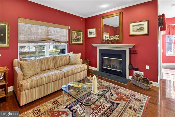 a living room with furniture a front door and a fireplace