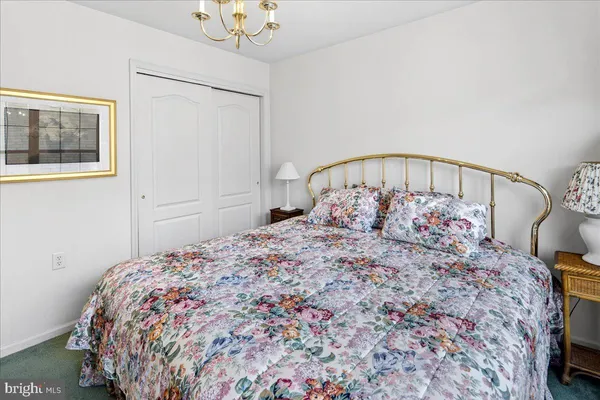 a large bed sitting in a bedroom next to a window