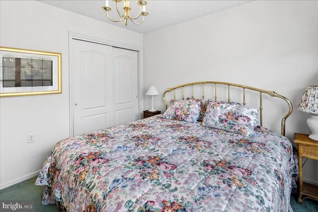 a large bed sitting in a bedroom next to a window