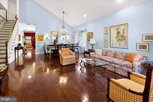 a living room with furniture or wooden floor and a large window