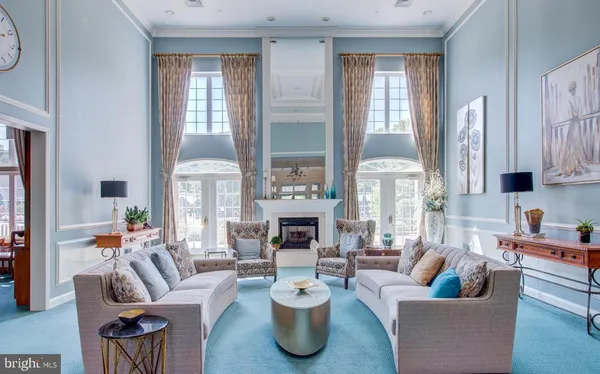 a living room with fireplace furniture and a large window