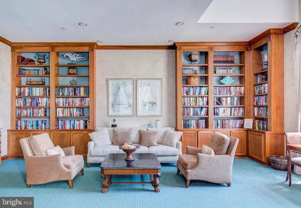 a living room with furniture workspace and a book shelf