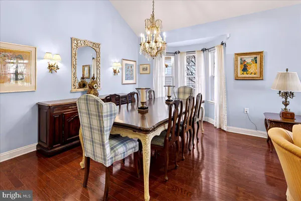 a view of a a dining room with furniture window and wooden floor