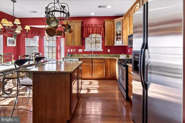 a view of a dining room with furniture a chandelier and wooden floor
