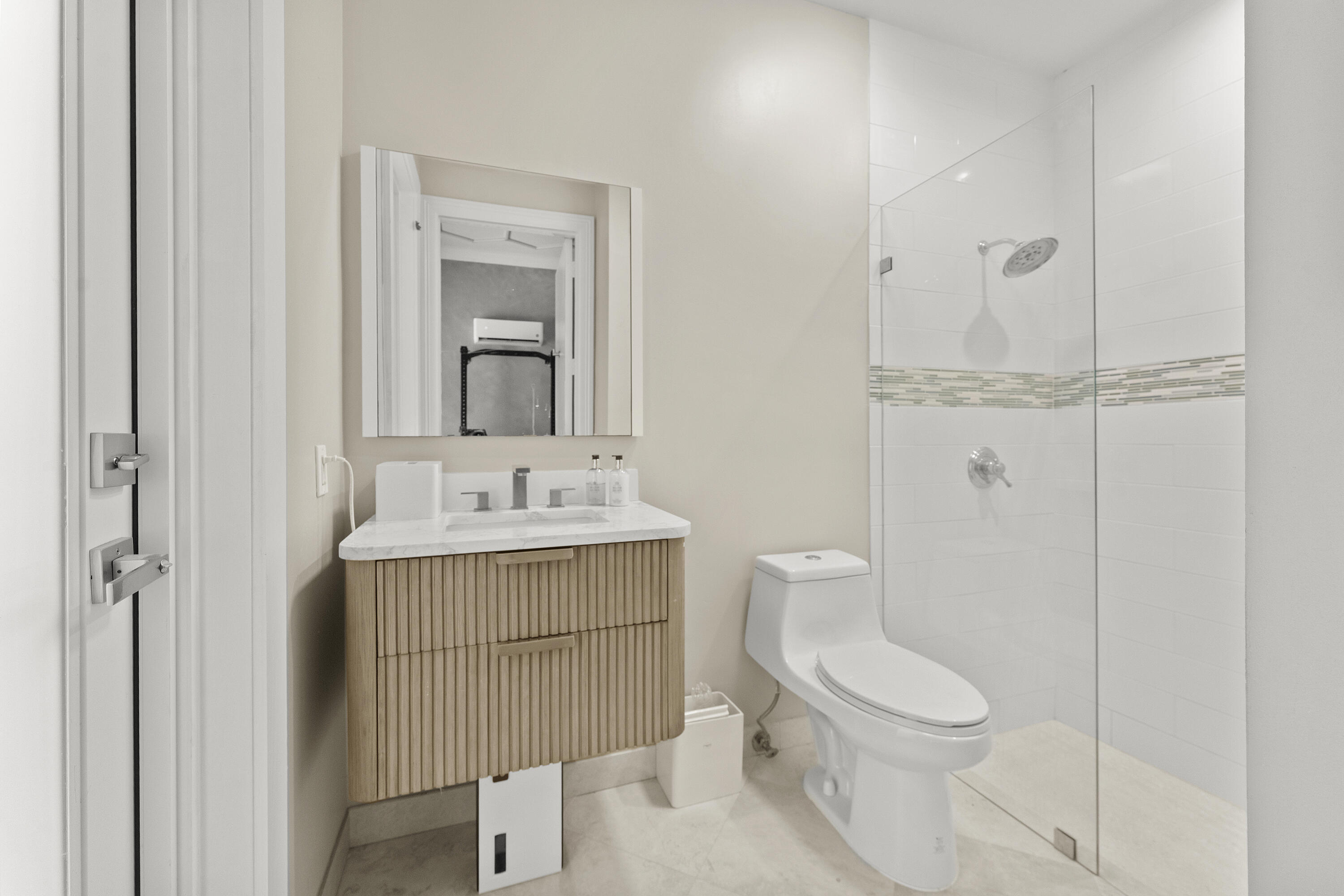 3156 Northwest 61st Street Boca Raton, FL 33496 - Photo 35 of 46 a bathroom with a toilet a sink and mirror