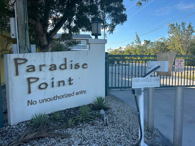 a view of a street with a small yard