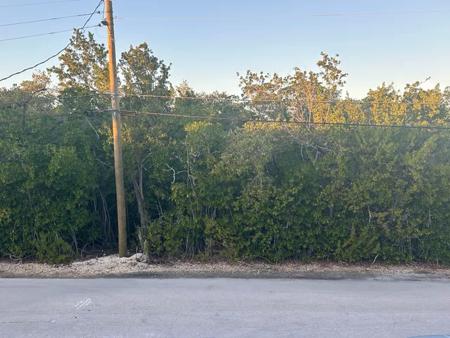 a sign of the house next to a yard