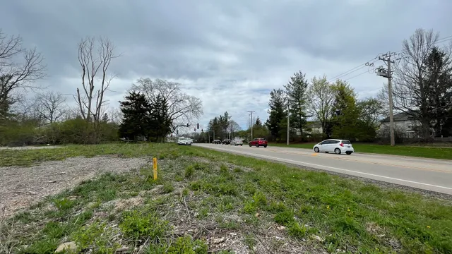 a view of a field with trees in background
