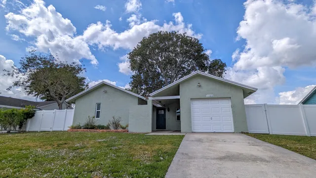 a front view of house with yard and trees