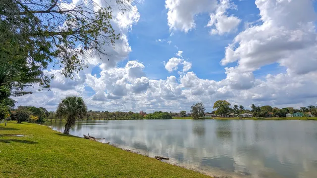 a view of residential houses with outdoor space and lake view