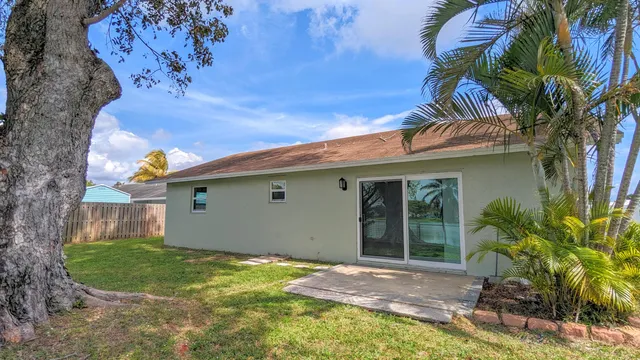 a view of backyard with swimming pool and green space