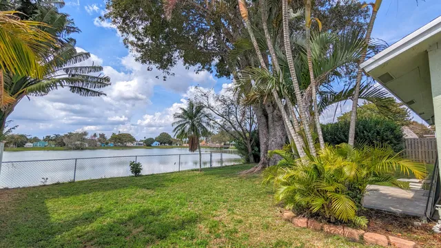 a view of a house with garden and trees