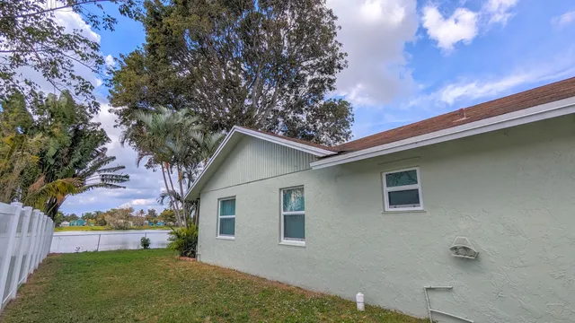 a view of house with backyard