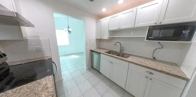 a view of a hallway with chandelier and chandelier