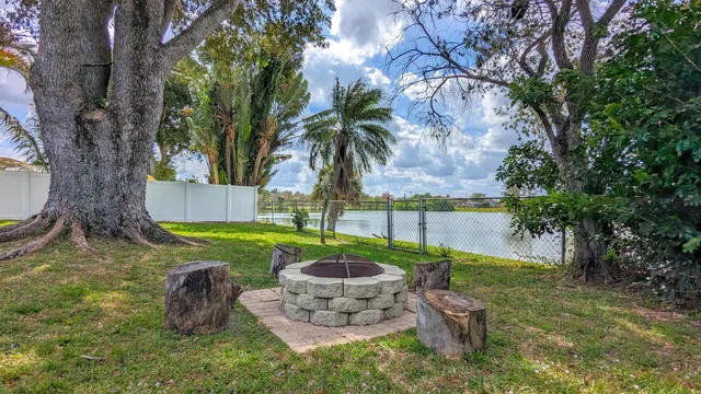 a view of a backyard with plants and a patio