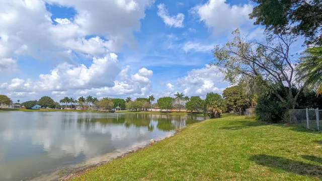 a view of a lake with houses in the background
