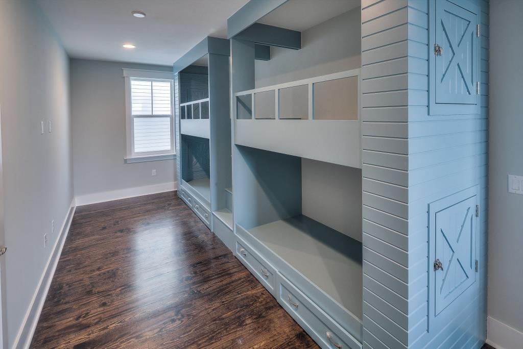 107 Flatwoods Forest Loop Santa Rosa Beach, FL 32459 - Photo 14 of 21 a hallway with wooden floors and staircase