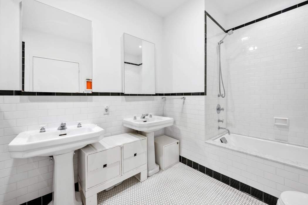 525 West 22nd Street, Unit 3AF Manhattan, NY 10011 - Photo 12 of 20 a bathroom with a sink and a mirror