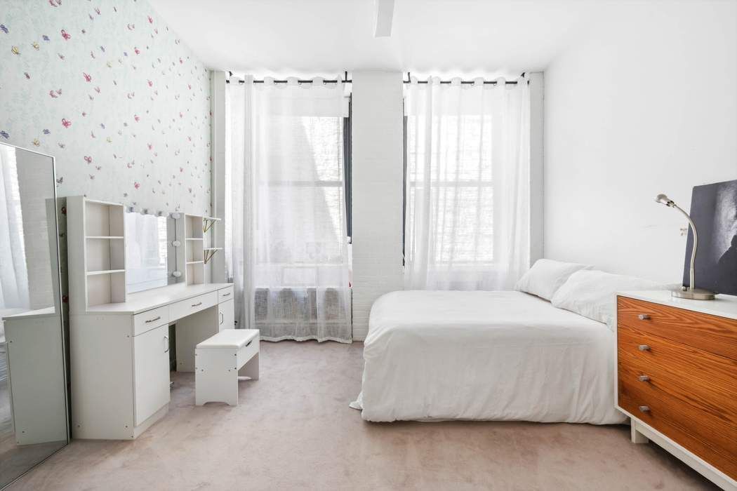 525 West 22nd Street, Unit 3AF Manhattan, NY 10011 - Photo 13 of 20 a bedroom with a bed and a window