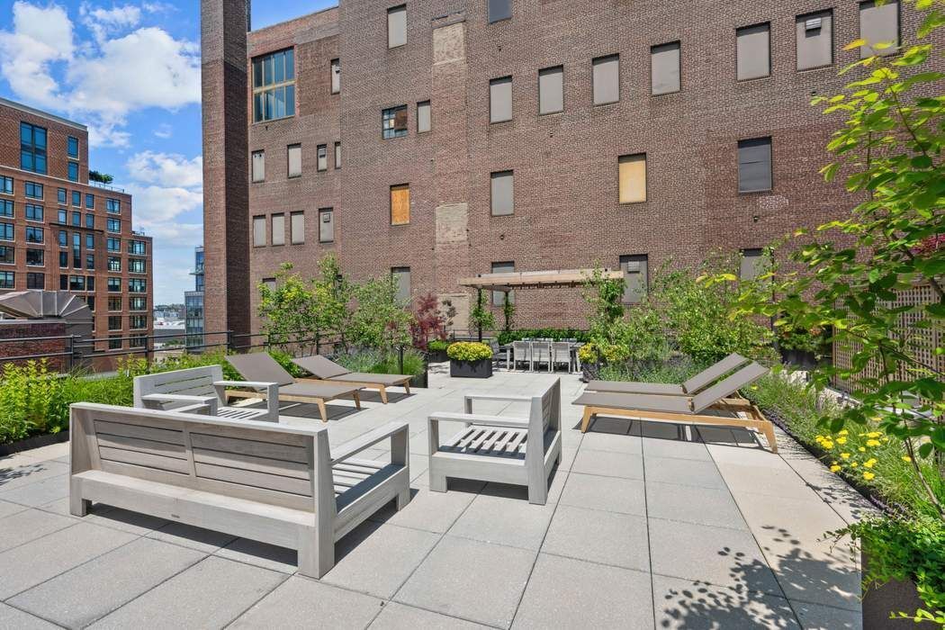 525 West 22nd Street, Unit 3AF Manhattan, NY 10011 - Photo 18 of 20 a view of a patio with a table and chairs and potted plants