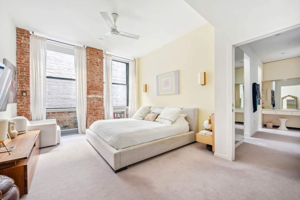 525 West 22nd Street, Unit 3AF Manhattan, NY 10011 - Photo 7 of 20 a spacious bedroom with a bed and a couch