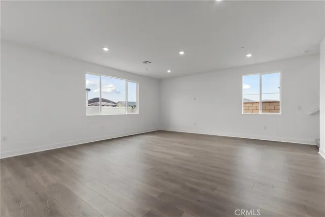 a kitchen with a sink and wooden floor