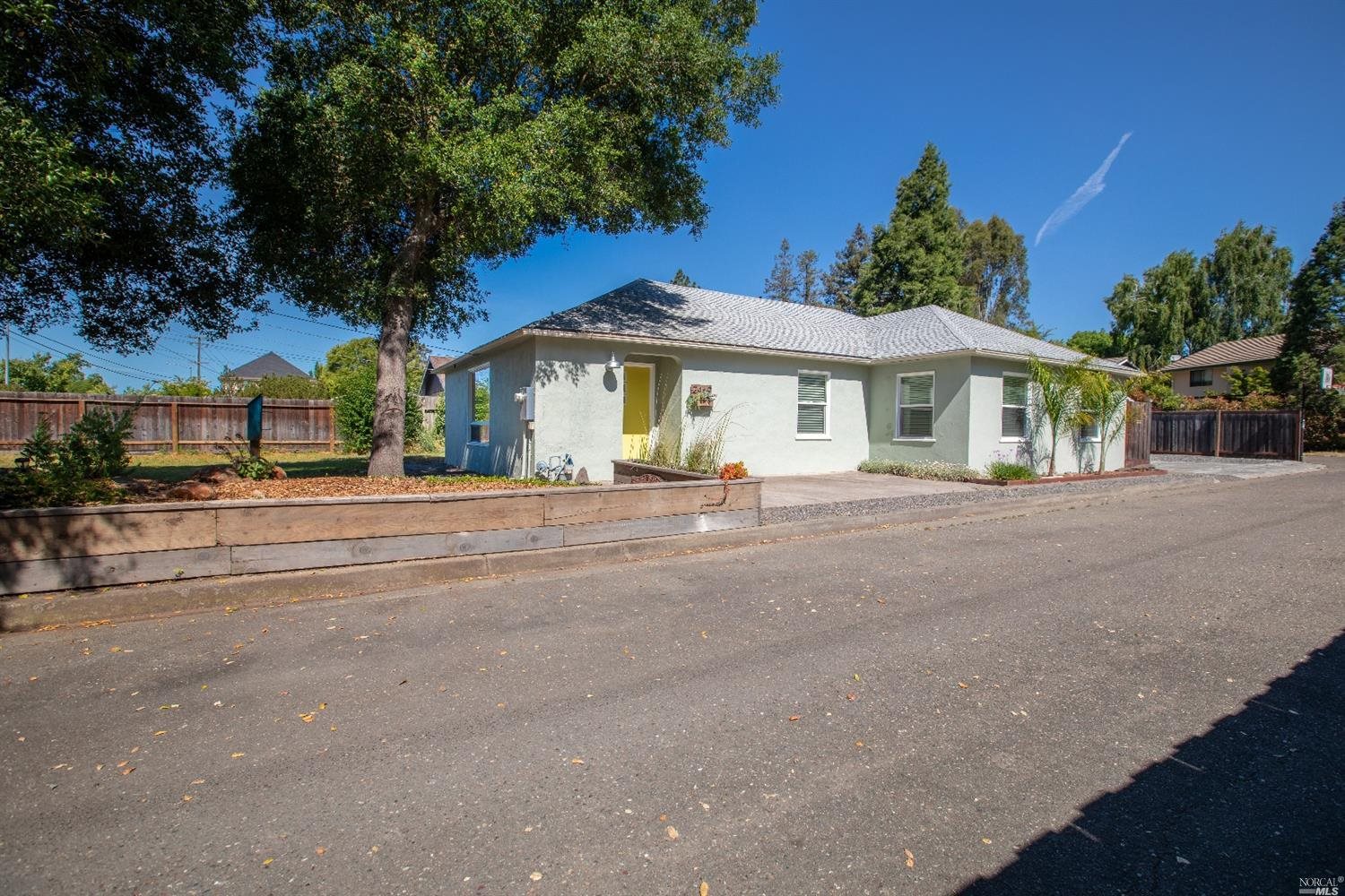2469 Guerneville Road Santa Rosa, CA 95403 - Photo 1 of 1 a front view of a house with a garden