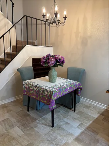 a dining room with furniture and chandelier