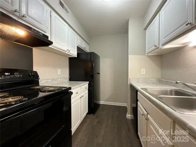 a kitchen with a stove and a sink