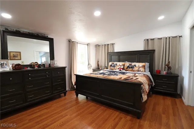 a bed sitting in a bedroom and mirror