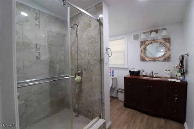 a spacious bedroom with a bed and a potted plant