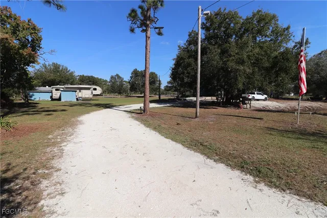 a park view with a barbeque