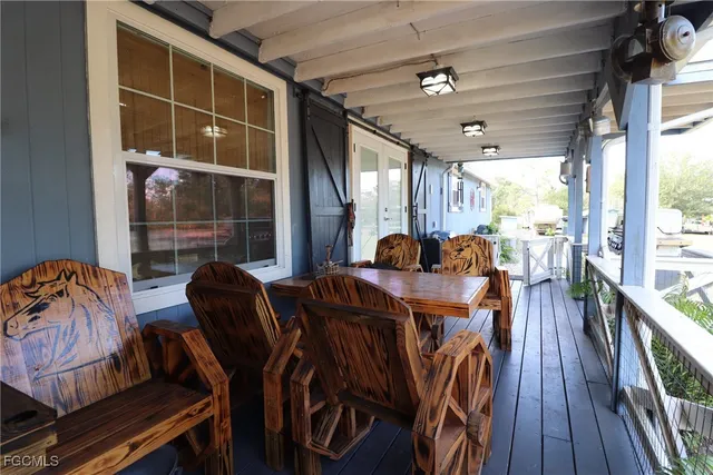 a view of a living room with hardwood floor and a flat screen tv