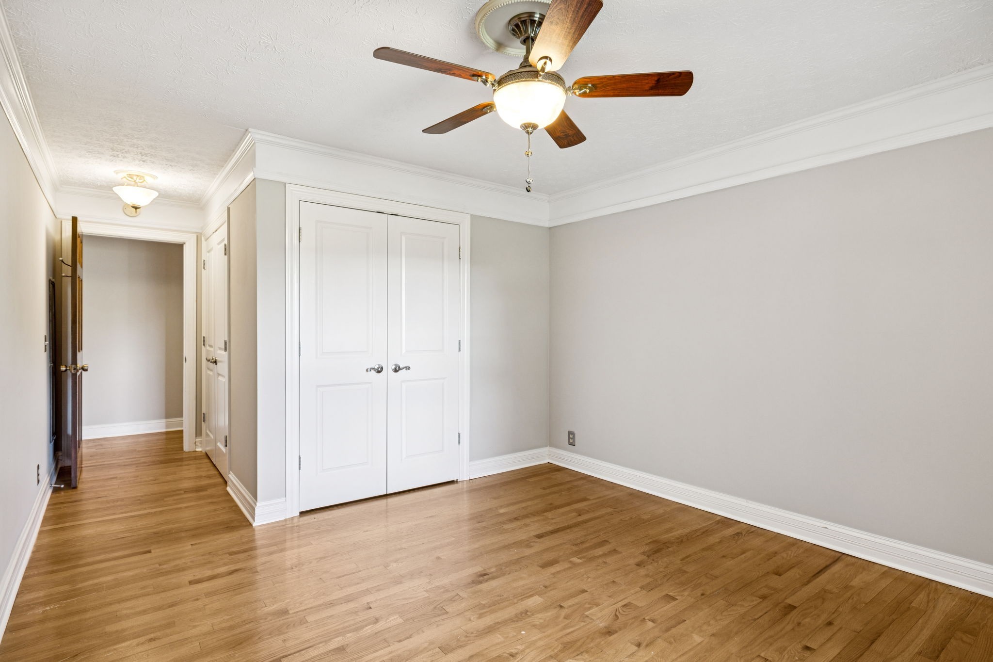 7144 Carter Road Fairview, TN 37062 - Photo 18 of 39 an empty room with wooden floor a ceiling fan and closet