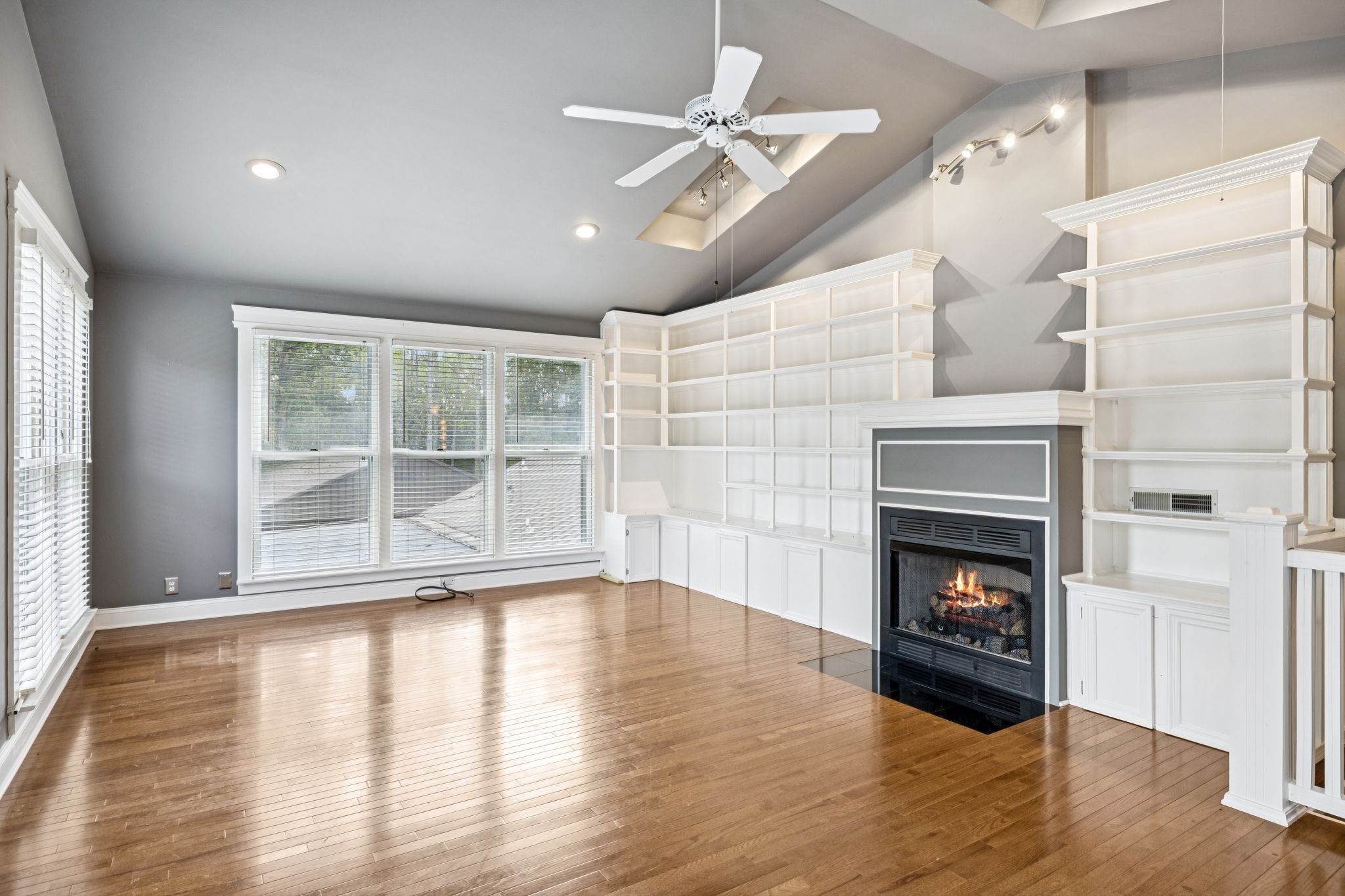 7144 Carter Road Fairview, TN 37062 - Photo 24 of 39 a view of an empty room with wooden floor fireplace and a window
