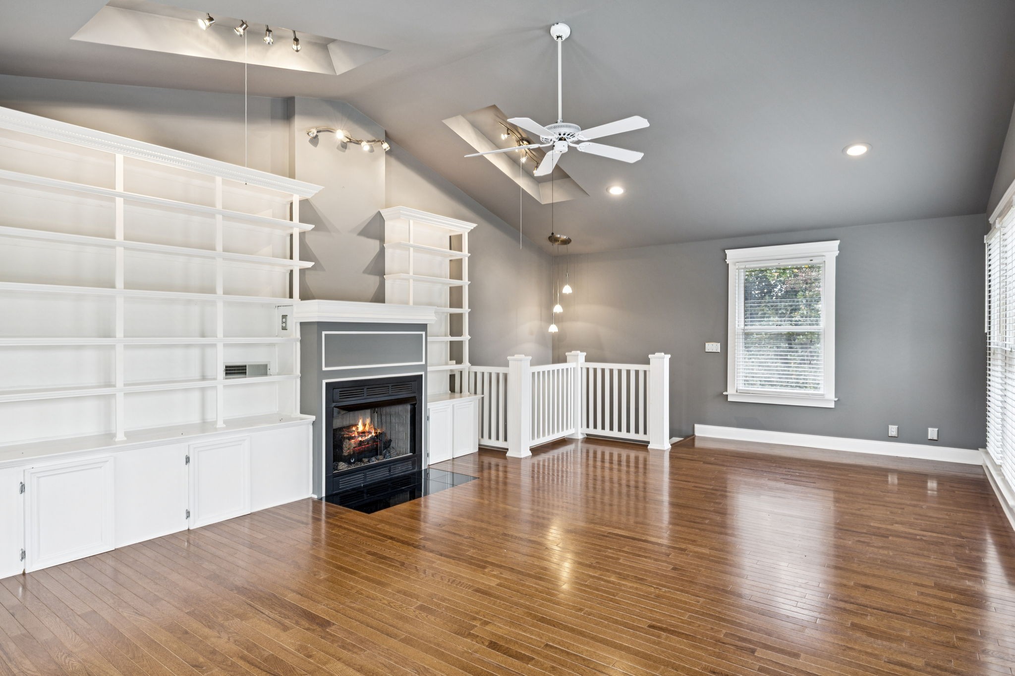 7144 Carter Road Fairview, TN 37062 - Photo 25 of 39 a view of an empty room with a fireplace and wooden floor