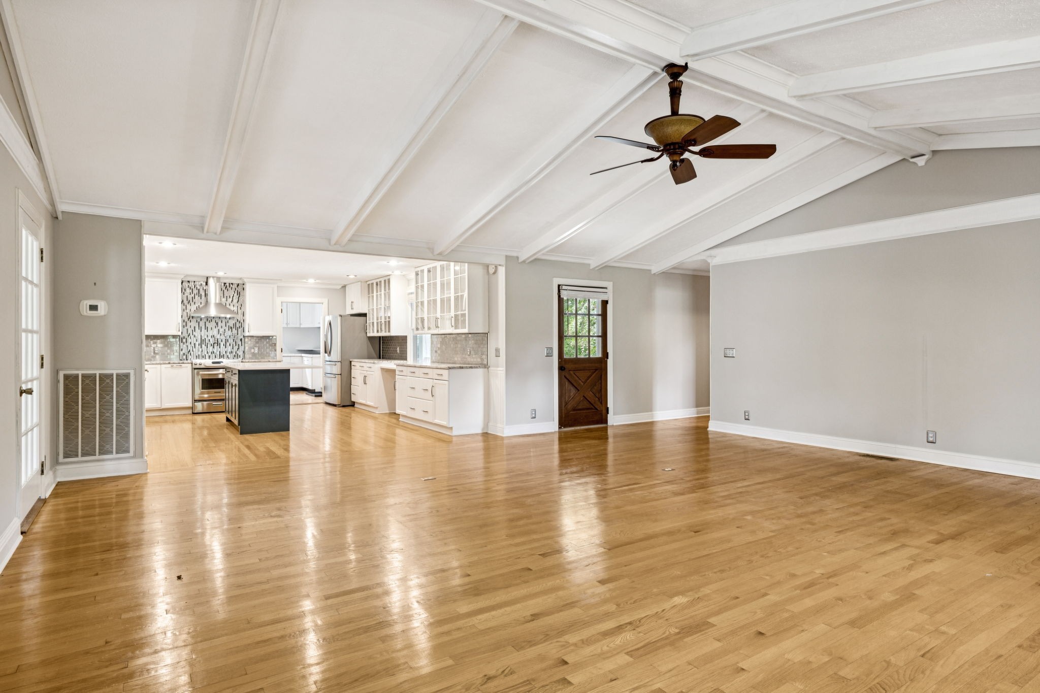 7144 Carter Road Fairview, TN 37062 - Photo 7 of 39 a view of an empty room with wooden floor and a ceiling fan