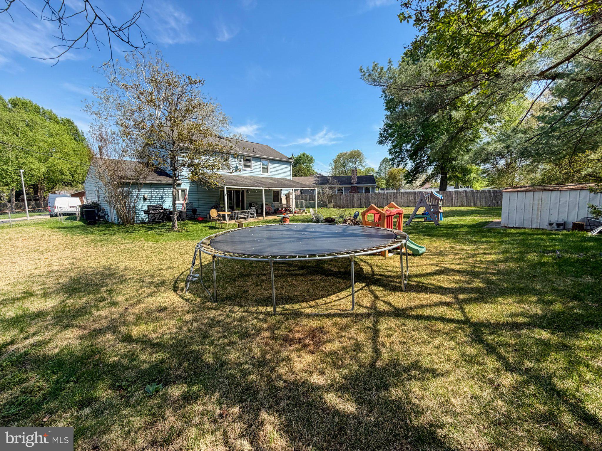 4717 Ramsgate Lane Bowie, MD 20715 - Photo 3 of 9 Sunny backyard with a trampoline.