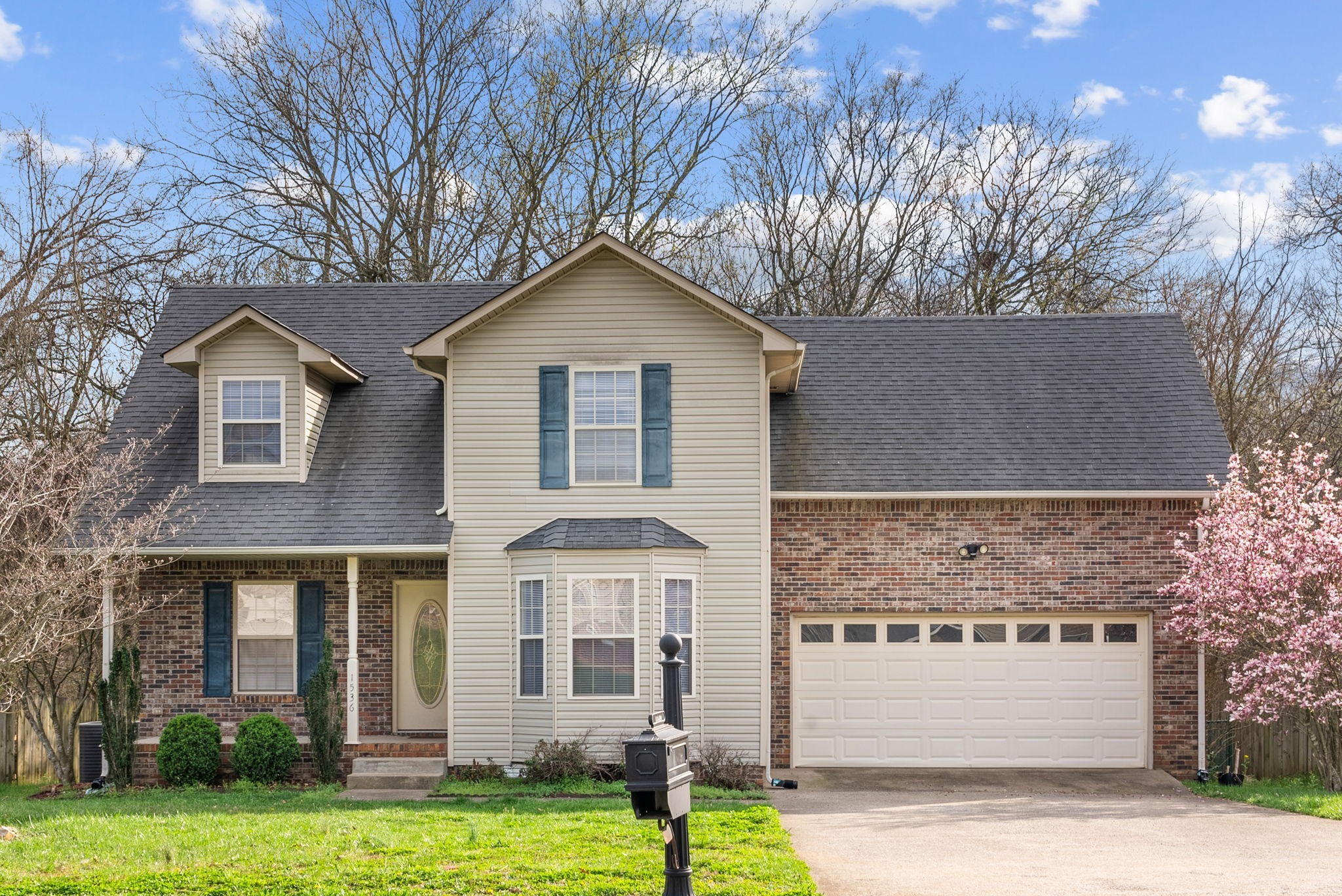 a front view of a house with a yard and garage