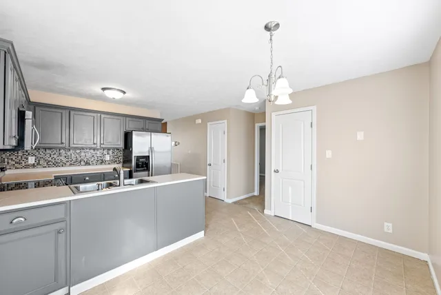 a kitchen with stainless steel appliances a sink stove and cabinets