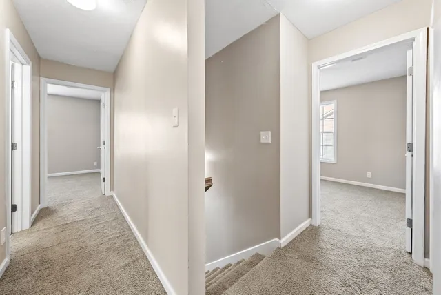 a view of a hallway with wooden shelves
