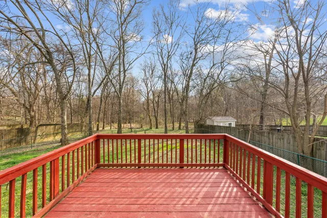 a view of a roof deck with wooden floor and fence