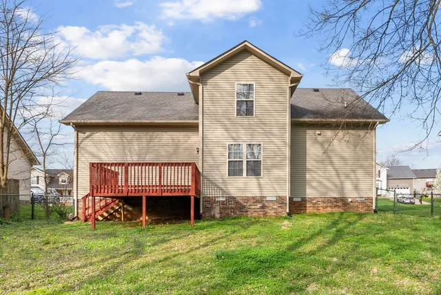 a front view of a house with a garden and plants
