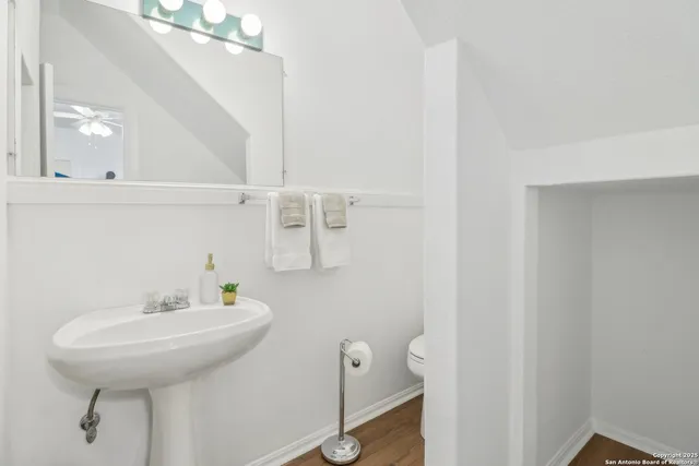 a bathroom with a sink a toilet and a mirror