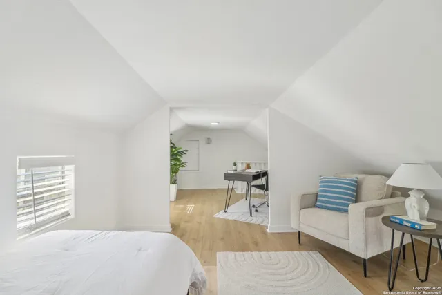 a bedroom with furniture and a wooden floor