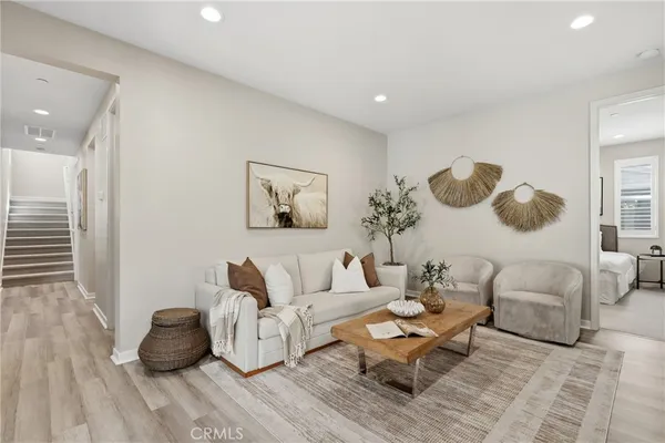 a living room with furniture and wooden floor