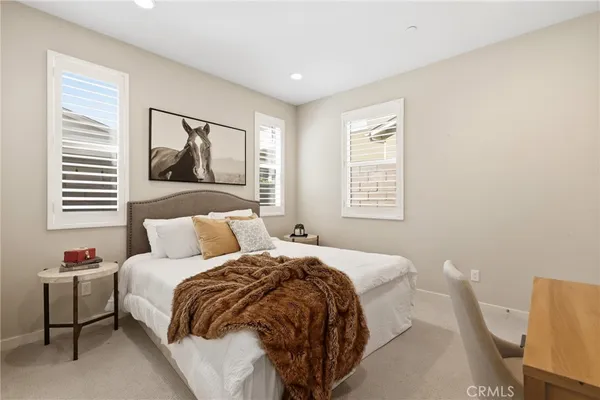 a bedroom with furniture and a window