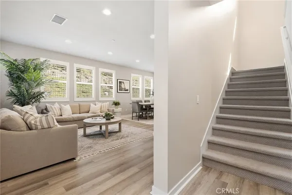 a spacious bedroom with a bed a couch and a window